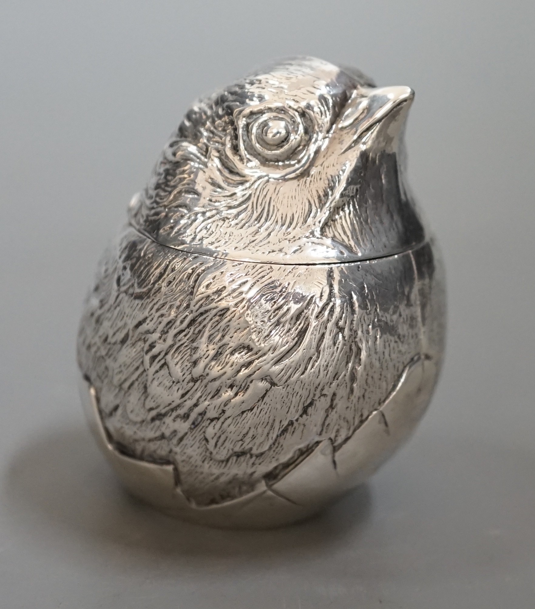 An early 20th century silver box with hinged cover, modelled as a hatching chick, Sampson Mordan & Co, Chester ?, marks rubbed, 64mm.